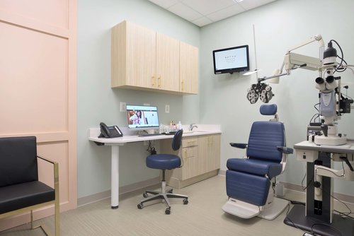 A fully equipped exam room with phoropter and slit lamp at Monroe Eye Care