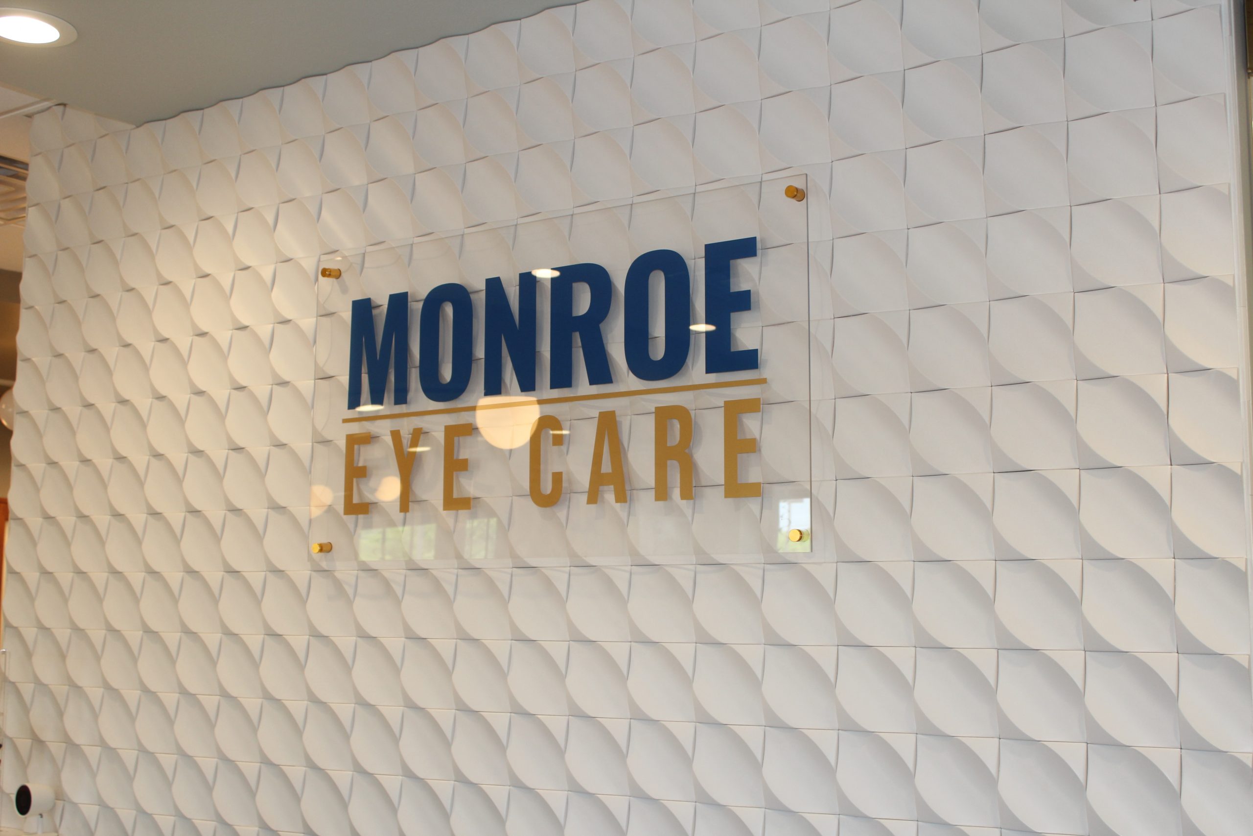 The Monroe Eye Care signage wall inside the practice