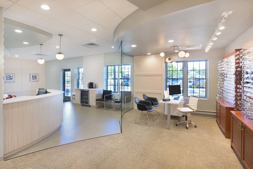 The open reception, waiting area, and eyewear wall at Monroe Eye Care